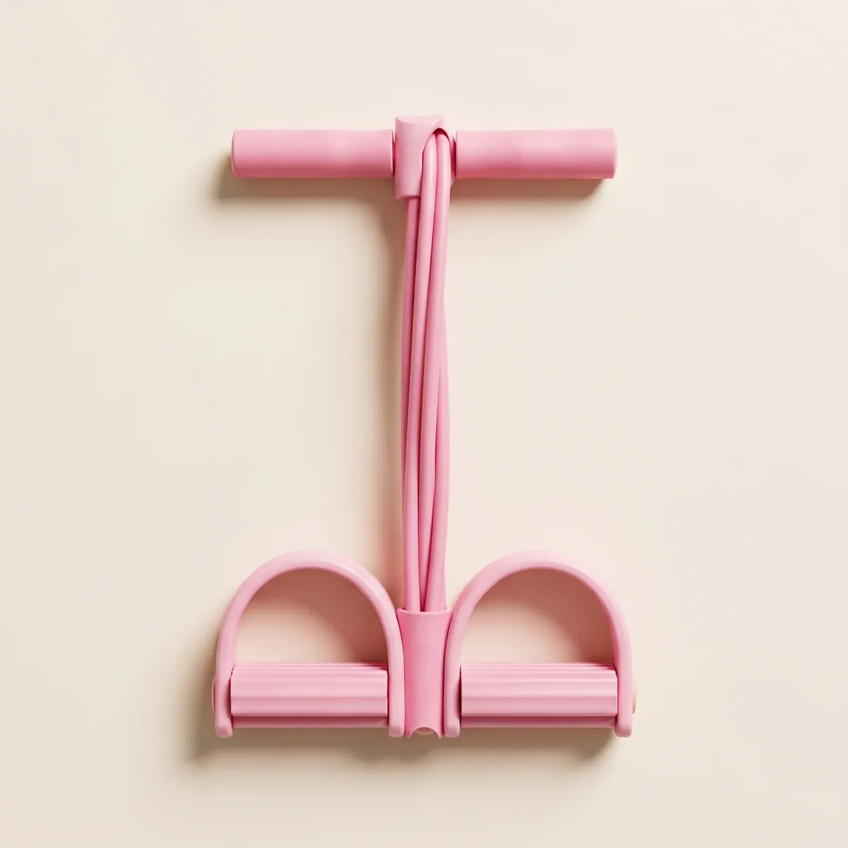 The Ankra Pedal Band laid out flat on a warm cream background: two handles at the top, six rubber tubes, foot pedals at the bottom